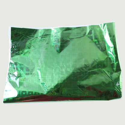 Person wrapping a present using metallic gift wrapping paper with stars