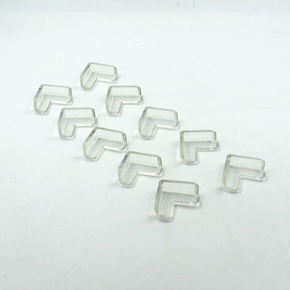 Multiple clear corner guards effectively applied to sharp furniture edges in a home.