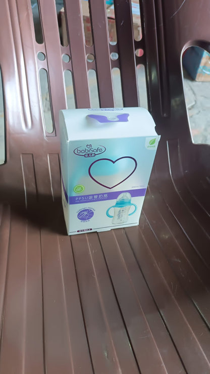 The complete Feedora baby feeding bottle set, including the bottle, straw, handles, and brush.