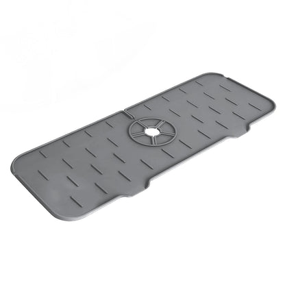 The silicone faucet mat shown in a bathroom setting, protecting the vanity from faucet drips and splashes.