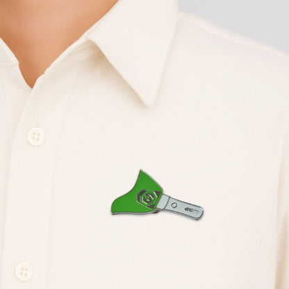 Close-up of metal badge pin attached on fabric showcasing enamel detail