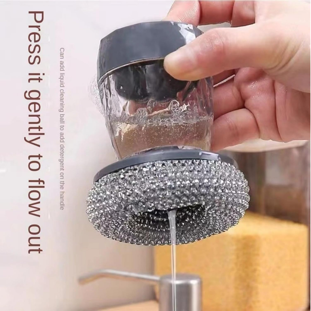 Close-up of the soap dispenser with scrub button, showing soap being dispensed onto a sponge.