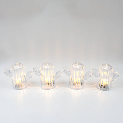 A hand holding a glowing cactus night light, demonstrating its portable and lightweight design.