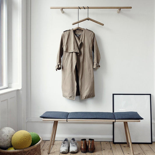 Single wooden clothes hanger with a notched design for coats and suits.