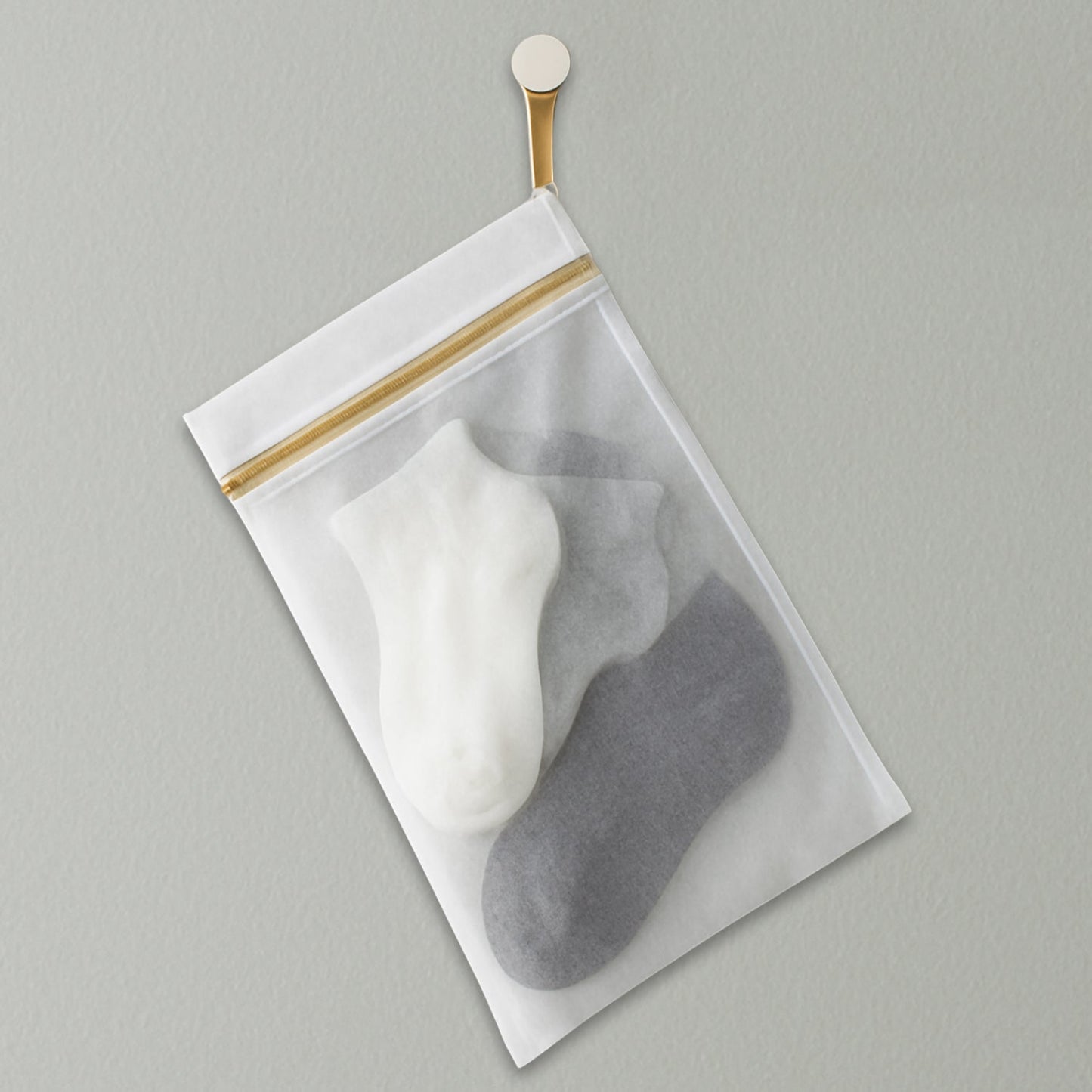Protecting delicates like bras and underwear in a mesh washing bag.