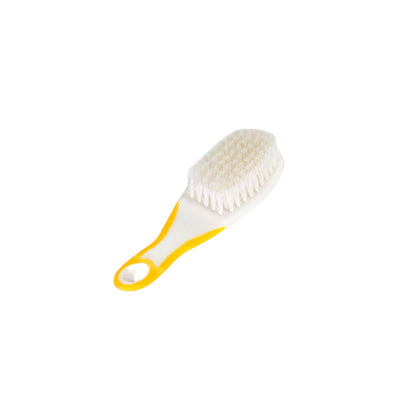 The Handle Grip Nail Brush positioned next to a bar of soap, ready for a hygienic nail cleaning session.