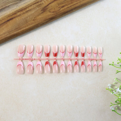 Full set of nude fake nails displayed for manicure use