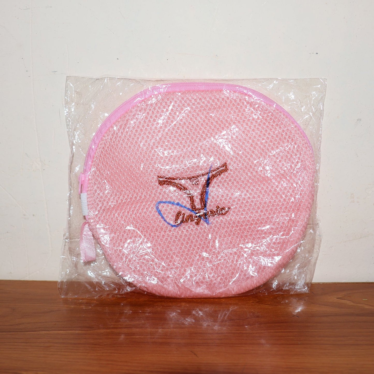 Various delicate garments neatly placed within the mesh laundry bag.