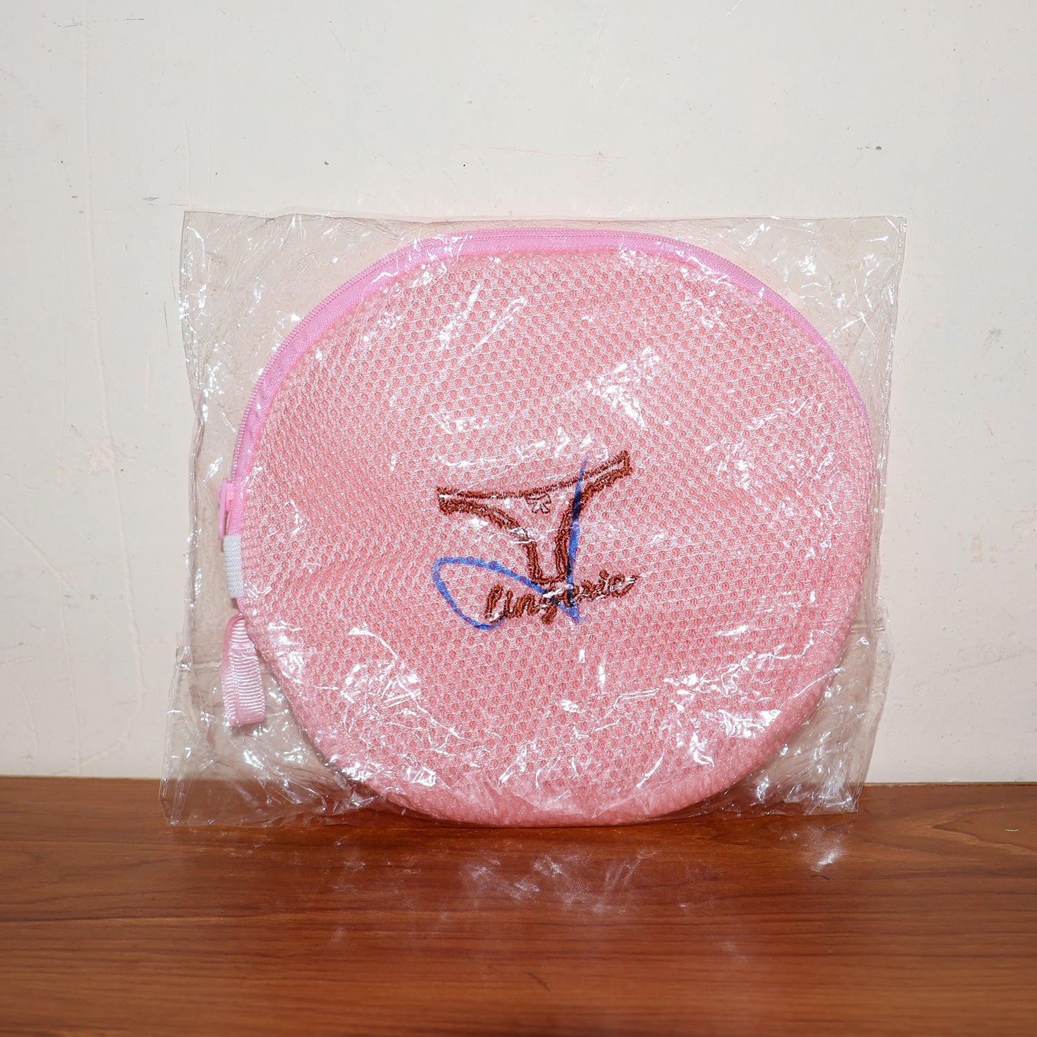 Various delicate garments neatly placed within the mesh laundry bag.