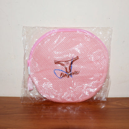 Various delicate garments neatly placed within the mesh laundry bag.