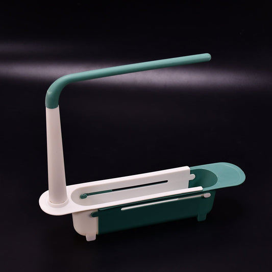 Expandable dish drying rack with a fresh sponge and brush, showcasing its adjustable feature over a sink.