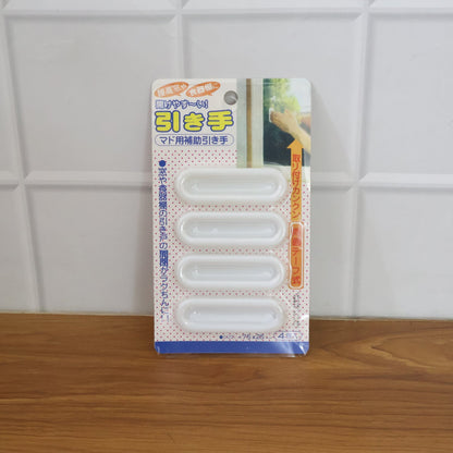 Set of stick on push pull handles used on kitchen and office cabinets