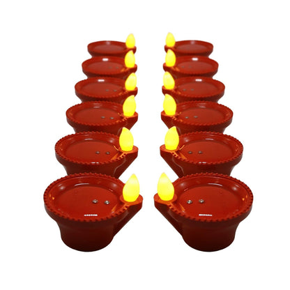Flameless LED diyas creating a traditional ambiance on a dark surface.