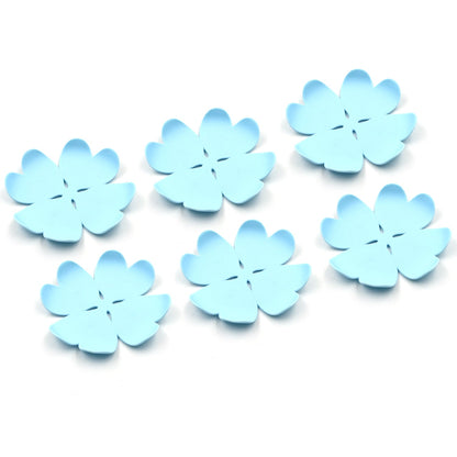 Assorted plastic heat resistant coasters in various designs, neatly arranged on a modern dining table.