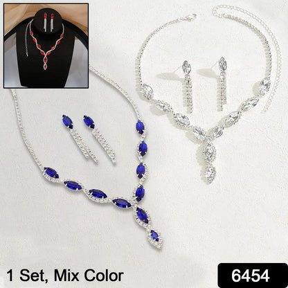 Close-up of a traditional Indian necklace and earring set with red stones.