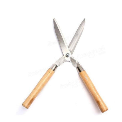 Indo Glow Hedge Shears resting on green foliage, ready for efficient garden maintenance.