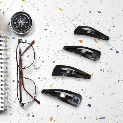 Matt black Metal Tic Tac Hair Clips on a neutral background, showcasing their sleek design.