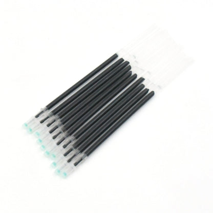 Multiple InkGlow black pen refills arranged neatly on a surface.