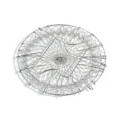 The durable stainless steel chef basket straining boiled vegetables for a healthy meal.