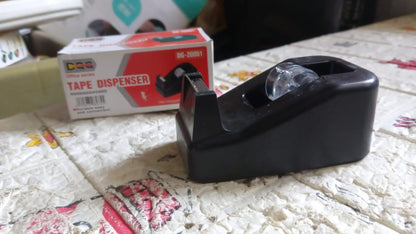 The VoltDesk tape dispenser in its original product packaging, displayed on a clean surface.