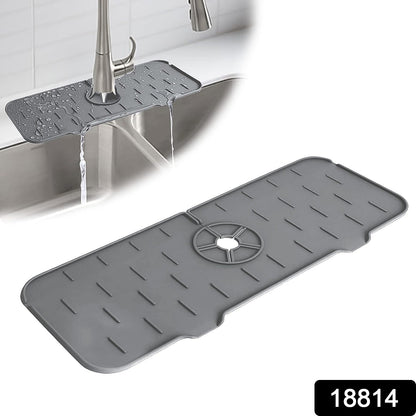 Close-up view of the flexible silicone faucet mat wrapping around a stainless steel kitchen faucet.