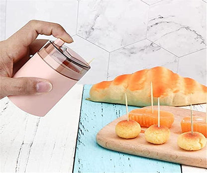 Hand demonstrating the easy automatic dispenser for toothpicks.