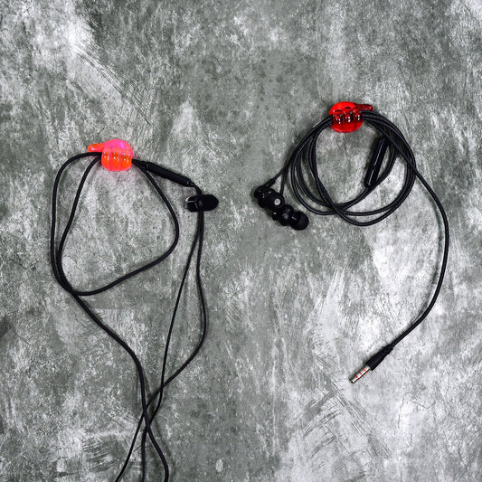 A set of multi-functional hand shape wall clips holding various items like cables and keys.