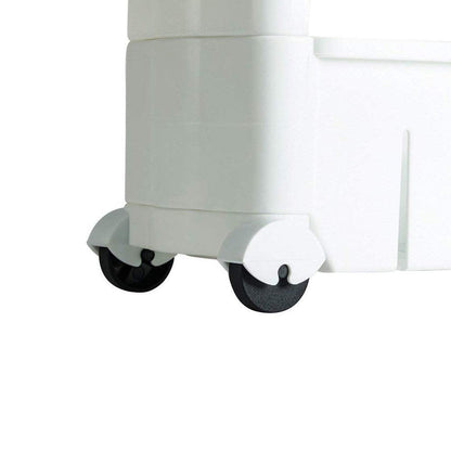 The slim storage rack positioned next to a kitchen appliance, showcasing its discreet fit.