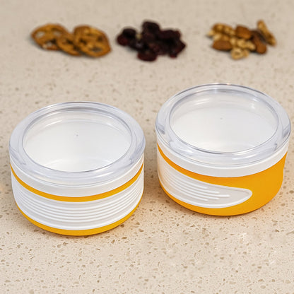 Two clear plastic airtight food containers with blue lids, stacked neatly.
