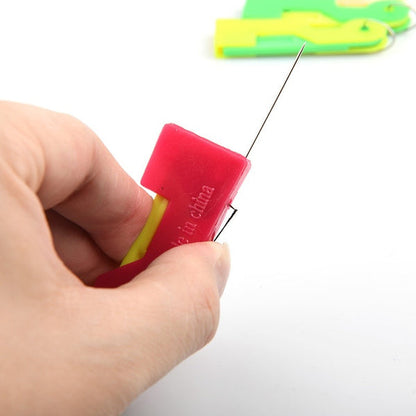 Vibrant multicolour automatic needle threader with a needle successfully inserted.