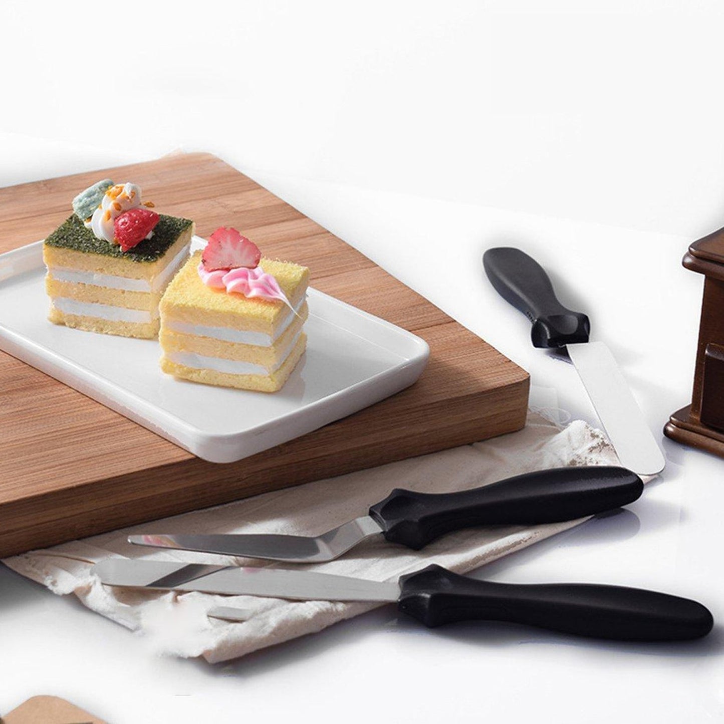 A complete set of stainless steel cake icing spatulas, featuring flat, angular, and triangle pallet knives.