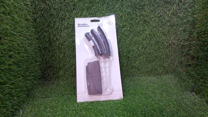A hand holding the ergonomic handle of the window blind cleaner brush, ready for use.