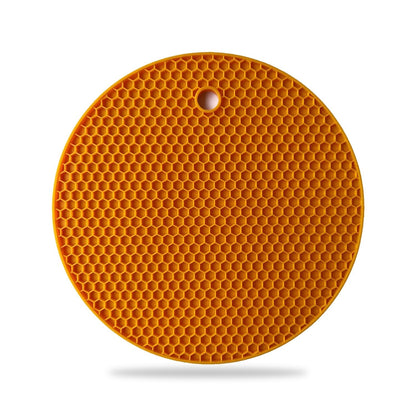 Durable silicone hot mat shown resisting high temperatures from a pan.