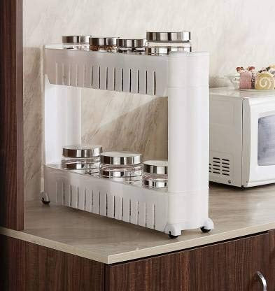 White slim storage rack on wheels, fitting perfectly into a narrow space next to a cabinet.