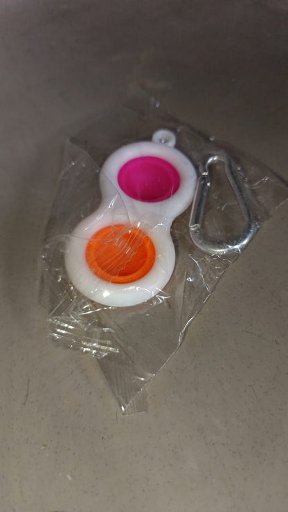 Pop It style fidget toy keychain, a fun sensory item.