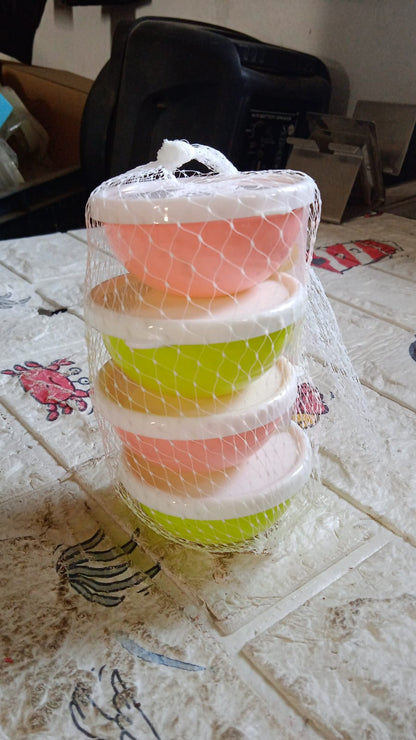 Small plastic bowls with lids placed inside a microwave oven, demonstrating safety.