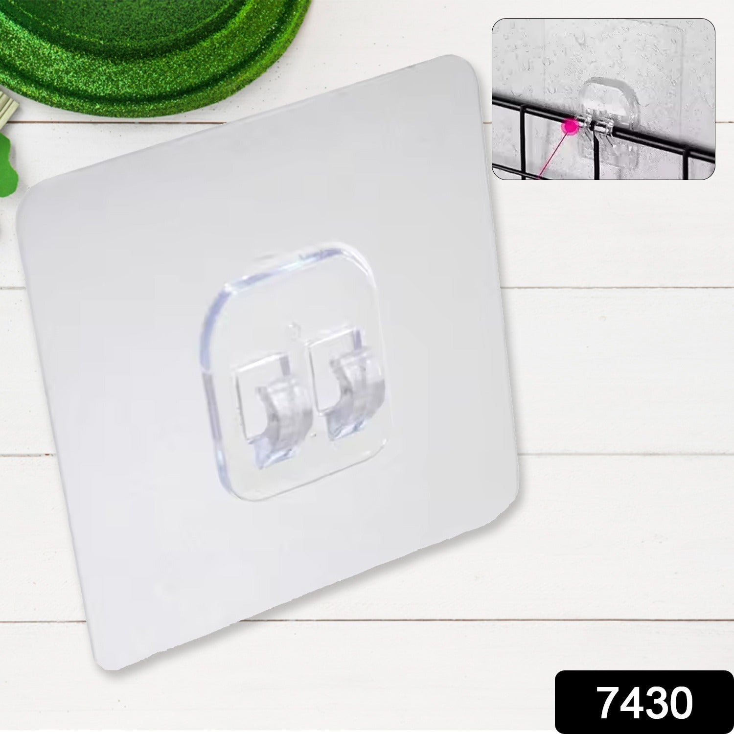 No-drill wall hook securely holding kitchen utensils on a tiled kitchen wall.