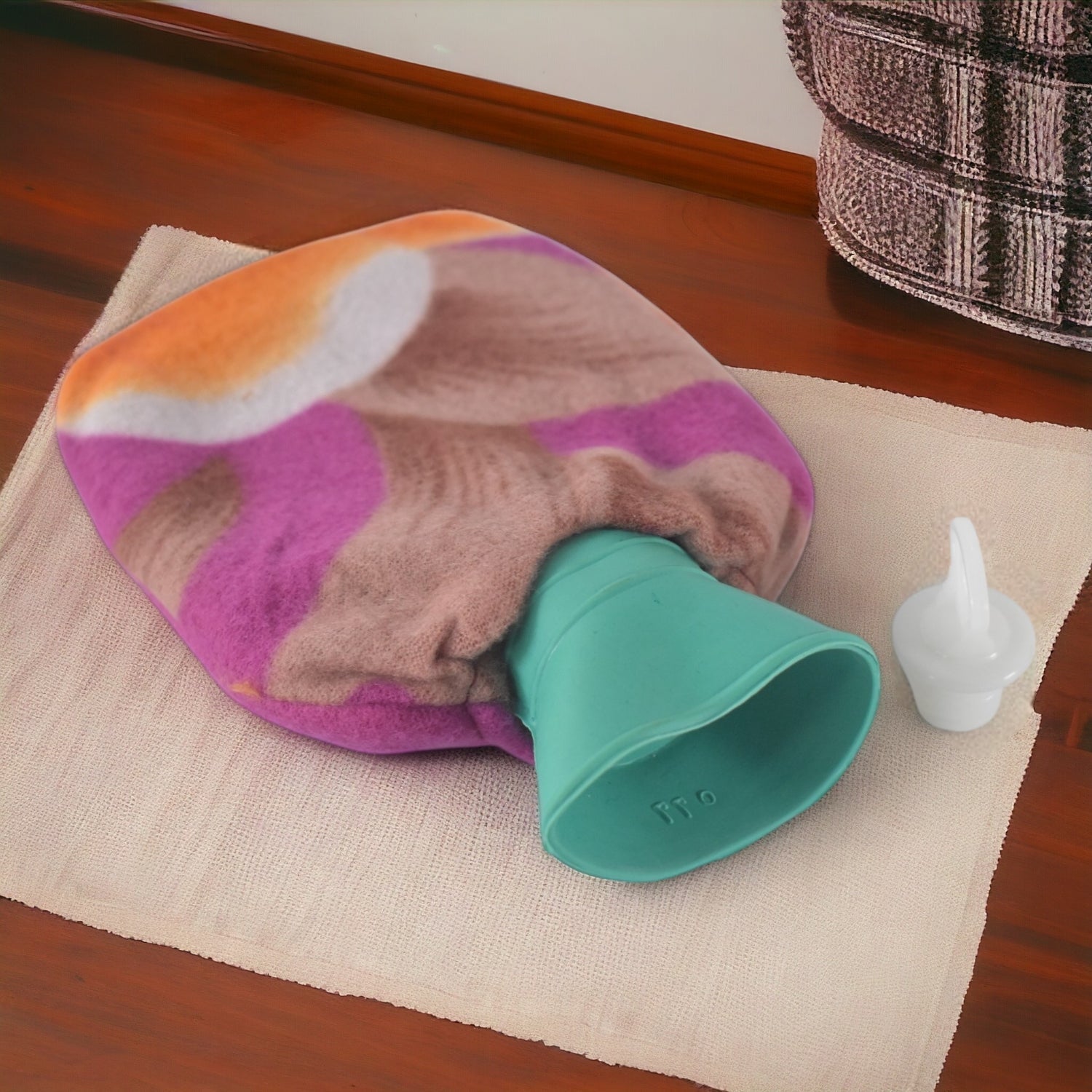Hot water bottle bag covered with cozy fabric sleeve for comfort