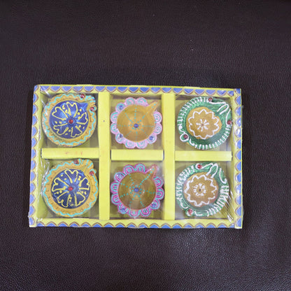 Brightly colored decorative clay diya with traditional motifs painted on it