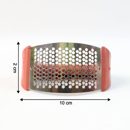 Close-up view of garlic being crushed by garlic press