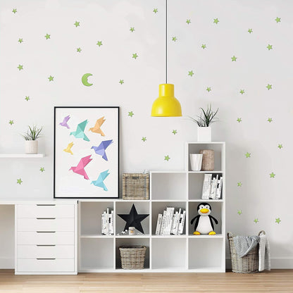 Fluorescent star and moon stickers glowing brightly at night, bringing the wonders of the cosmos indoors.