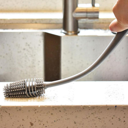 A bottle cleaning brush with a long handle, ideal for reaching the bottom of tall containers.