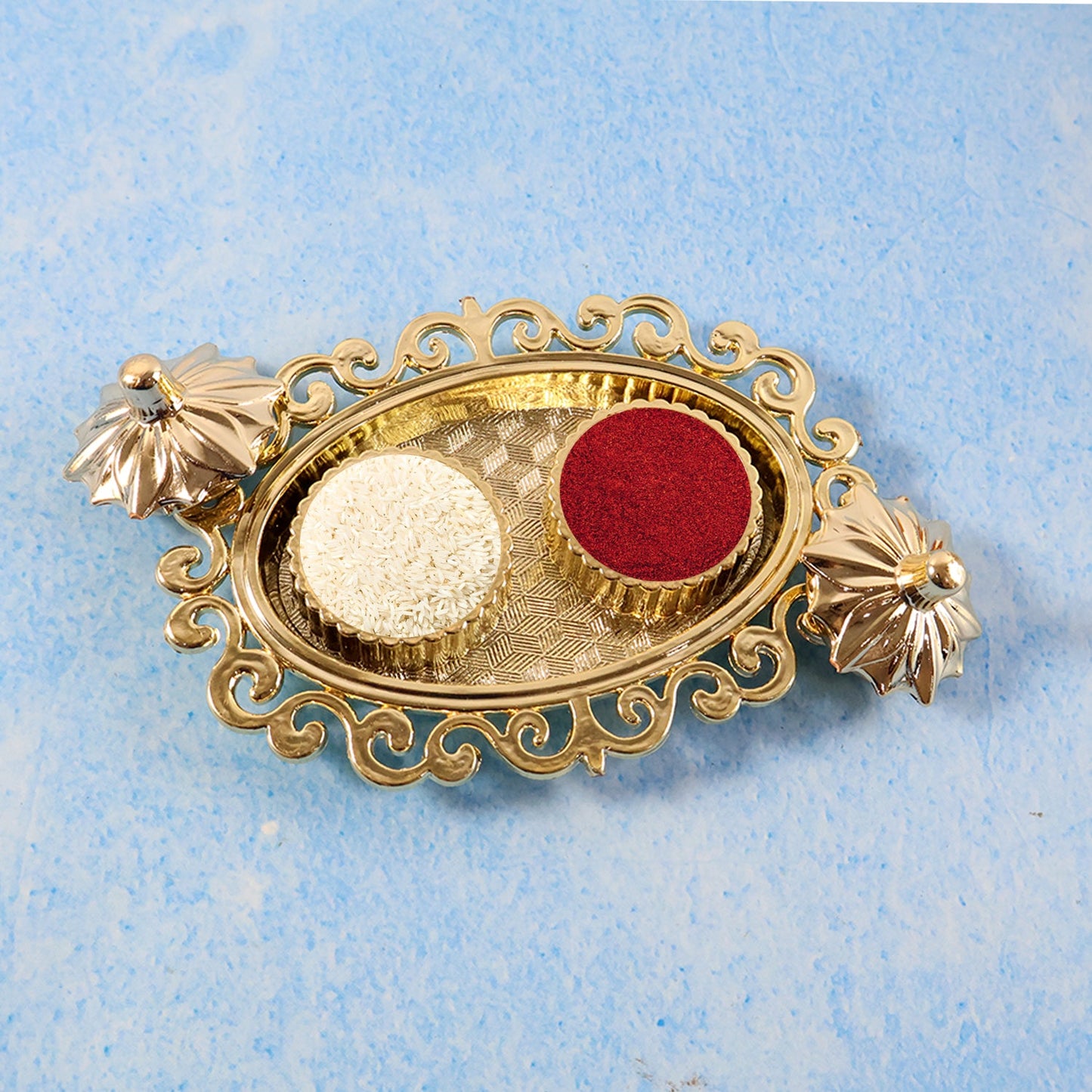 Ornate golden plastic pooja accessory for kumkum and roli storage