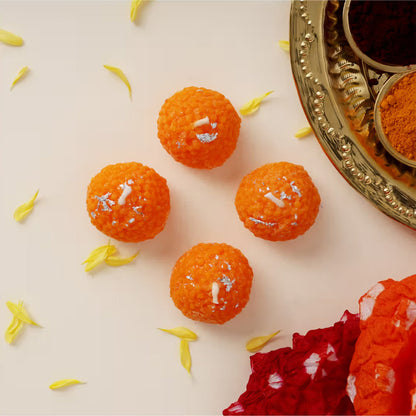 Festive table decoration with laddu shaped decorative wax candles lit