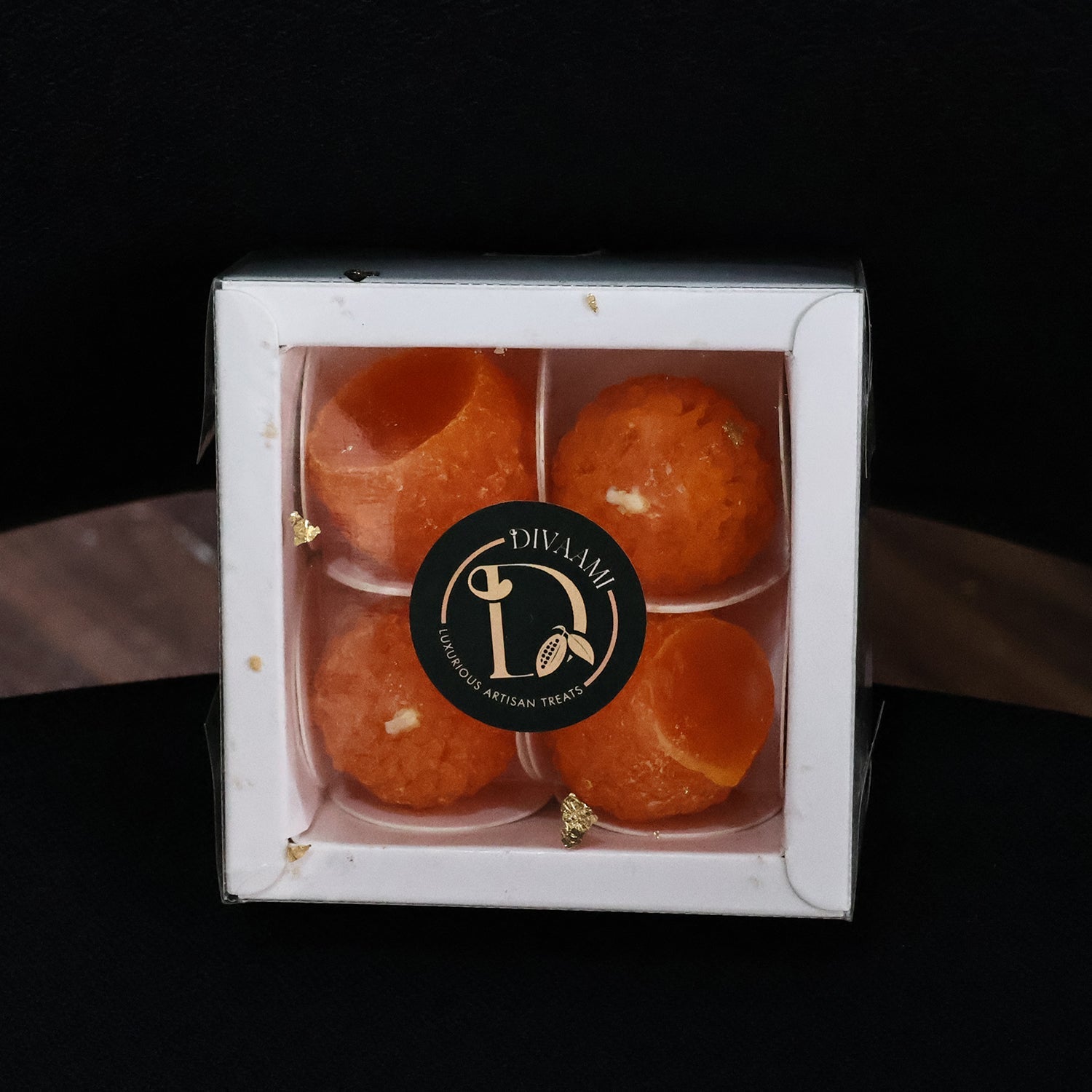 Lit laddu shaped decorative wax candle brightening traditional puja thali