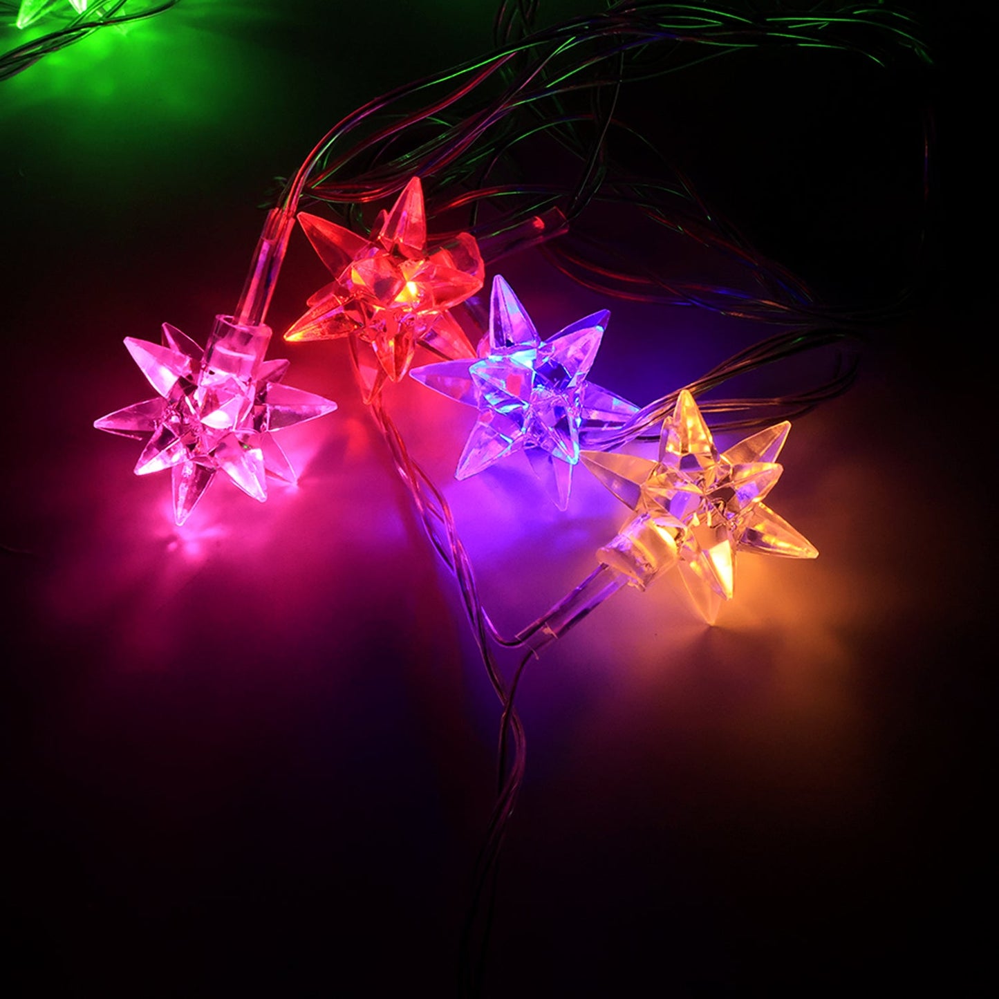 Flexible multicolor LED string light with star-shaped covers arranged for party decoration