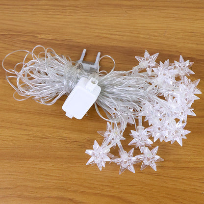 Multicolor LED star decorative string light plugged in and lit for indoor ambiance