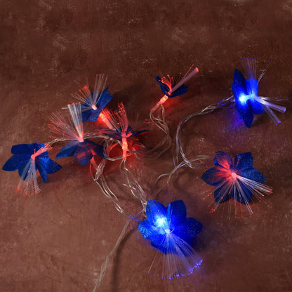 Decorative fiber flower LED string lights plugged in and illuminated in a home setting