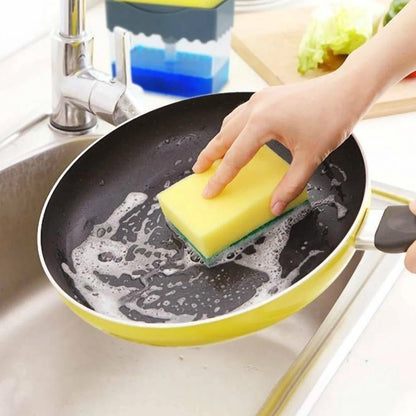Compact soap dispenser and sponge holder filled with dish soap next to a kitchen sink.