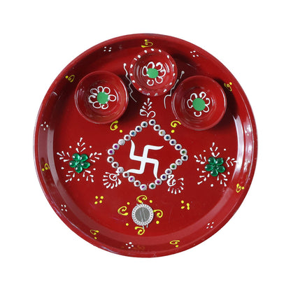 Three diyas arranged on vibrant hand-painted pooja thali for festivals